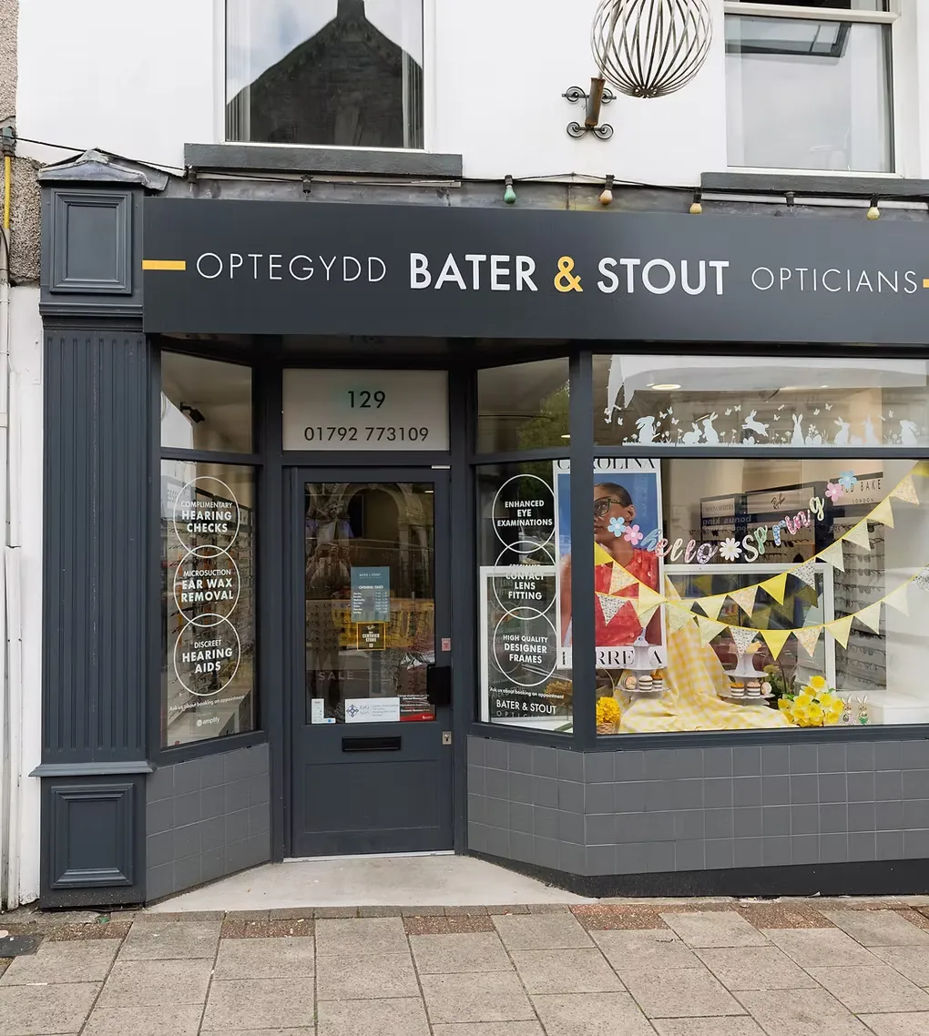 The Bater and Stout Opticians shopfront at 129 Woodfield Street, Morriston Swansea, with the OPTEGYDD fascia and amber ampersand